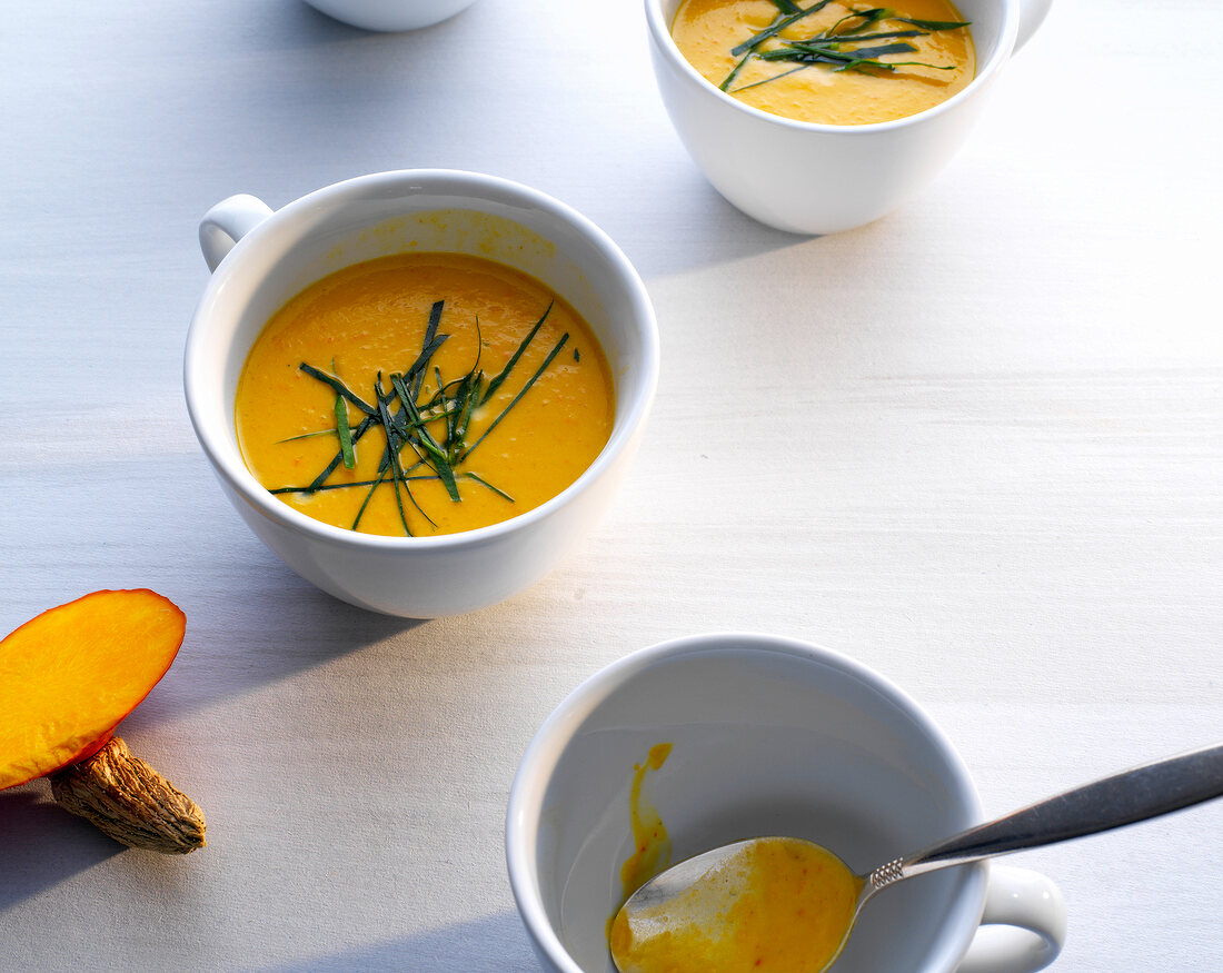 Thai pumpkin soup with basil in cups