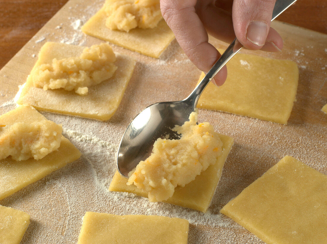 Filling on square shaped dough for preparation of biscuits, step 3