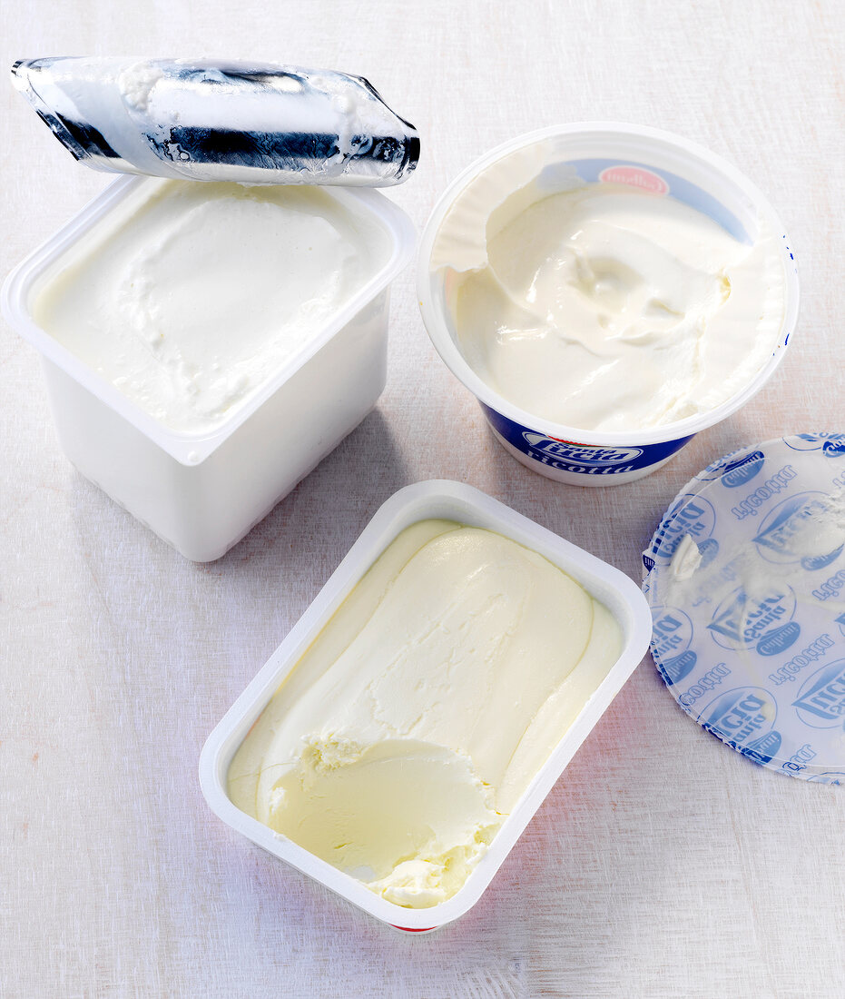 Ricotta cheese, cream cheese and cottage cheese in container 