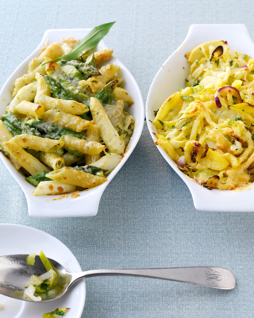 Penne and asparagus gratin and cheese spaetzle gratin in bowl