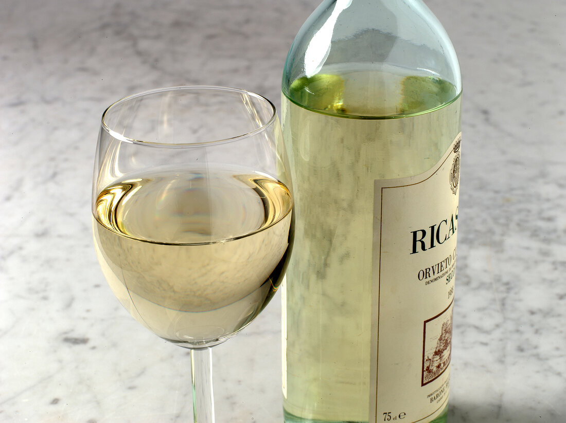 White wine in wine glass and bottle 