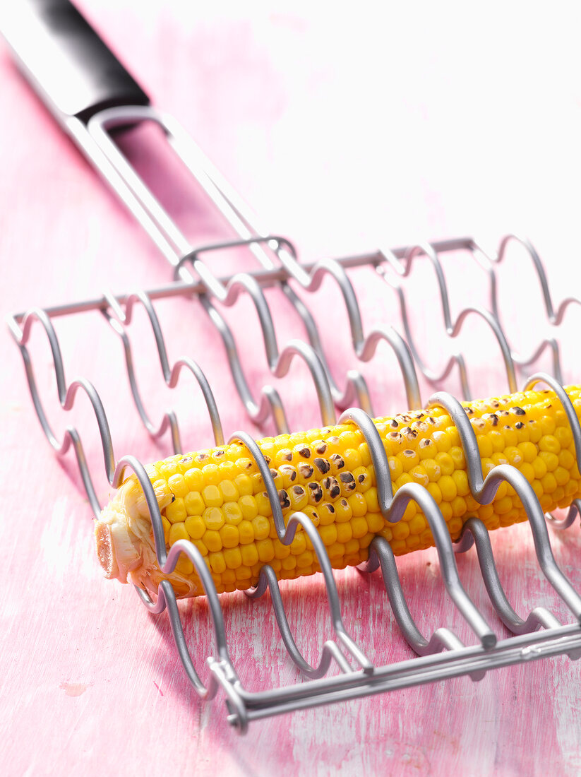 Corn cob in stainless steel grill holder
