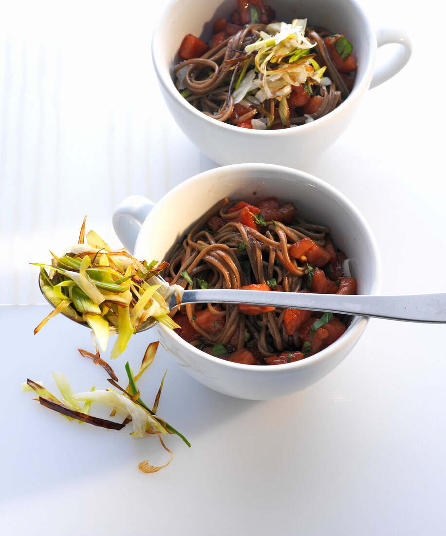 Soba noodle salad with raw tomatoes in cups