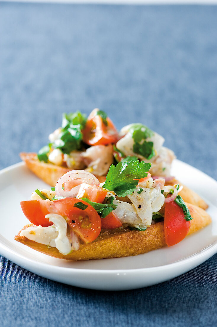 Close-up of tartar of sea bream with crostini on plate