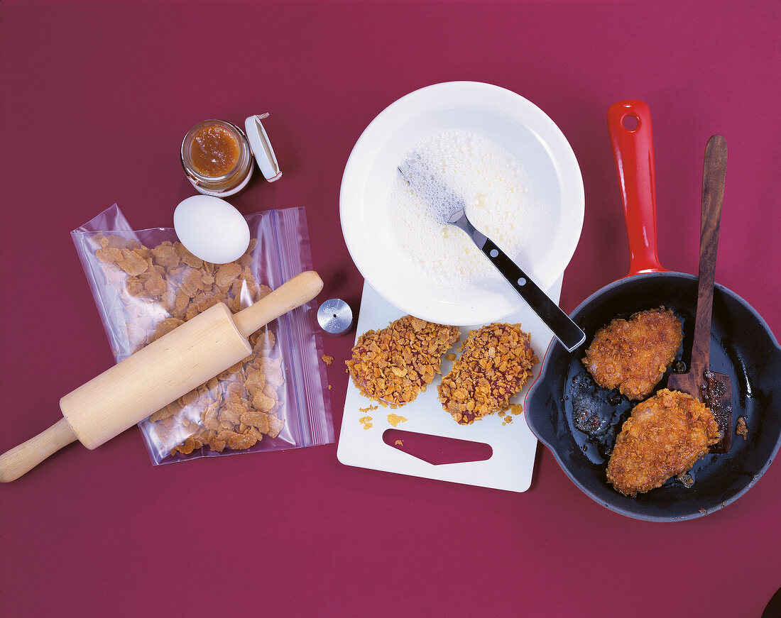 Cooked meat with breading from cornflakes on pan