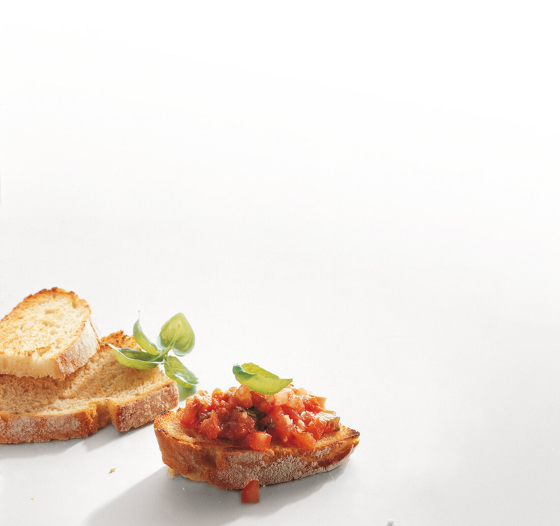 White bread slices with tomato crostini on white background