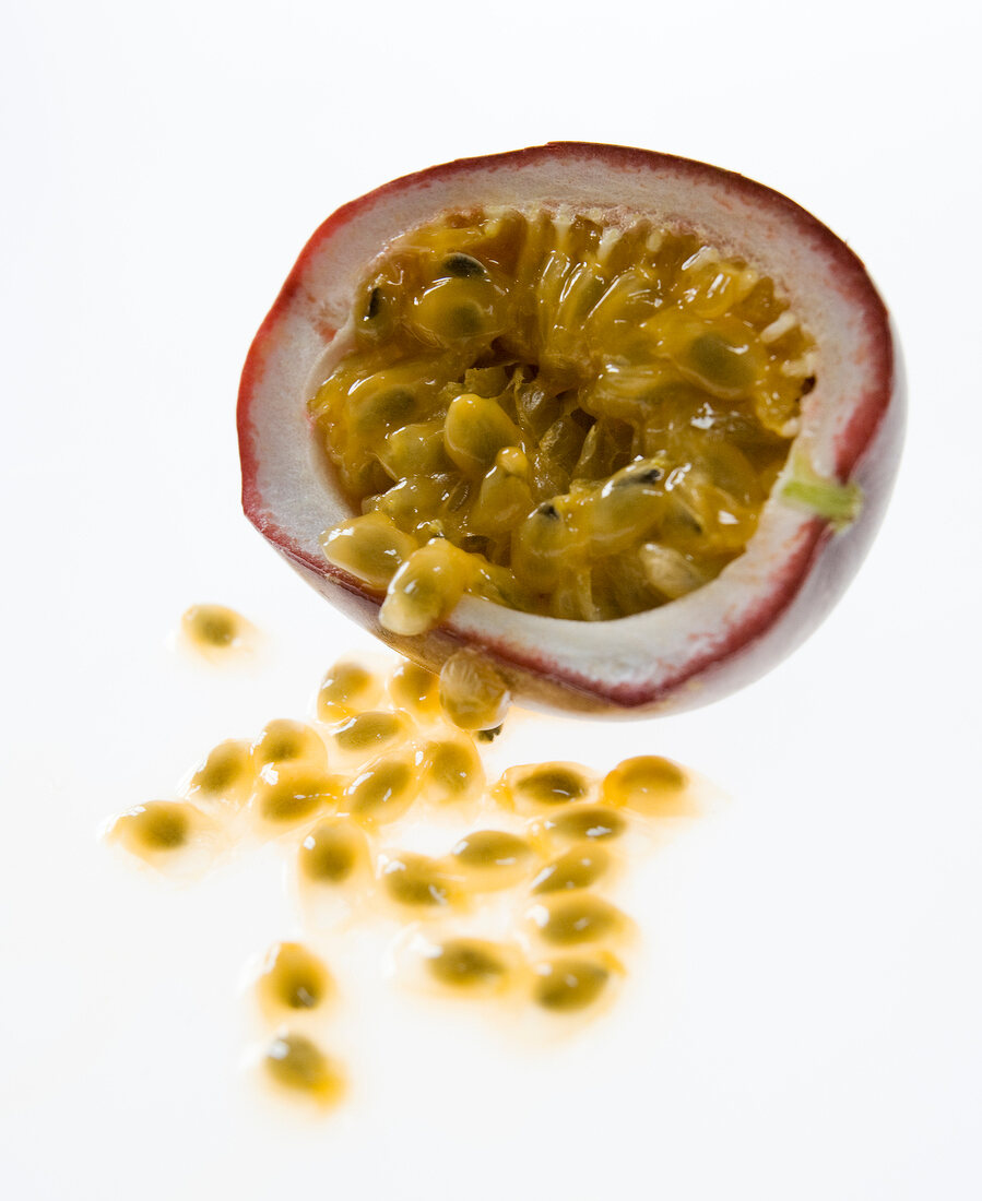 Close-up of halved passion fruit on white background