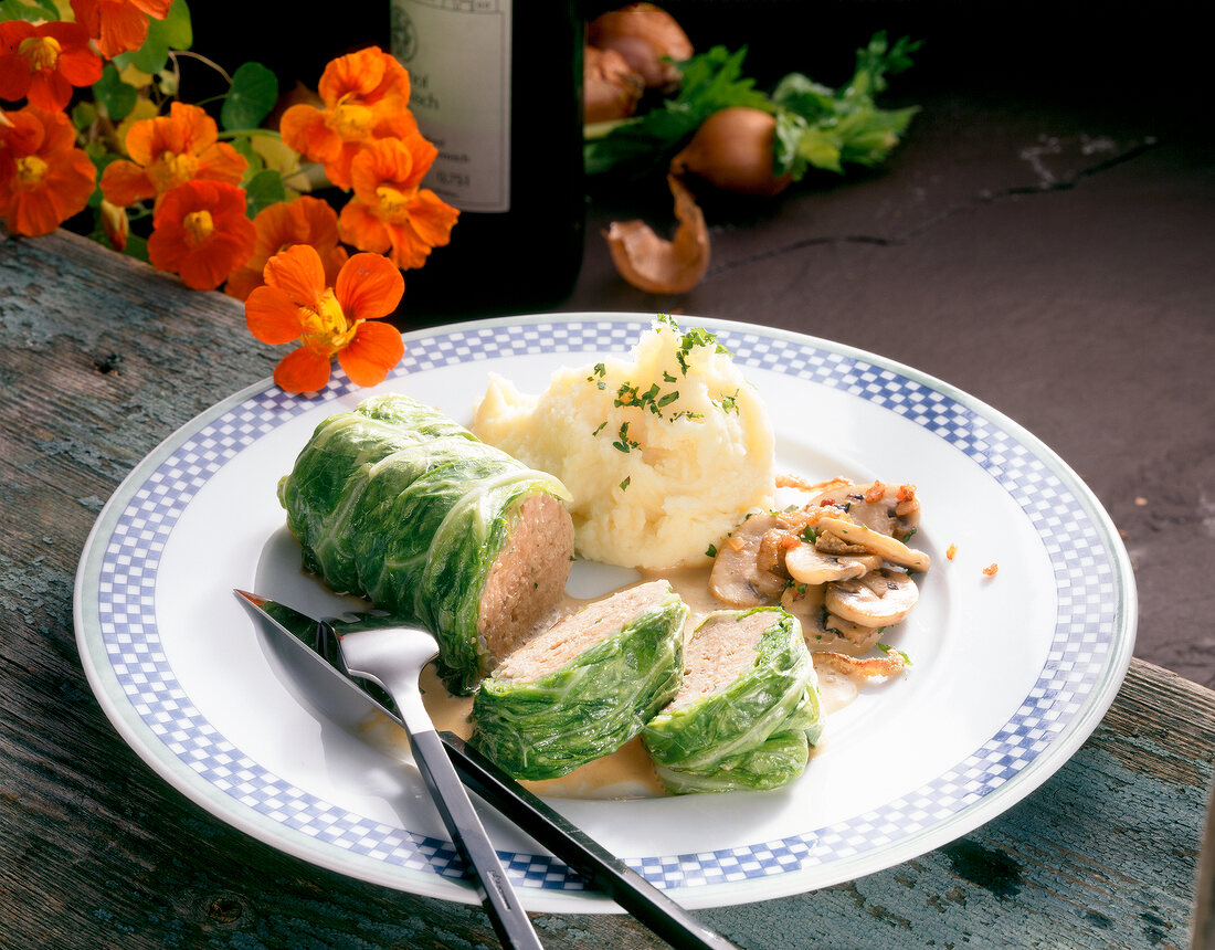 Duck savoy roulade with mashed potatoes on plate