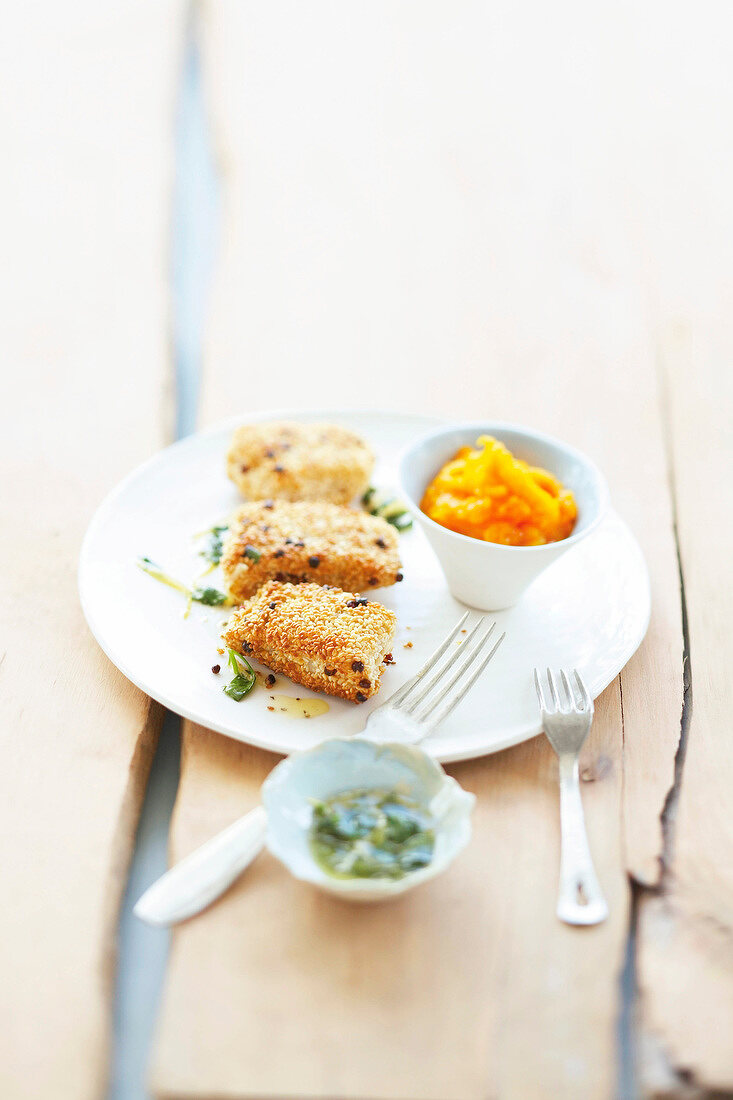 Fried hake served with carrots and pumpkin puree