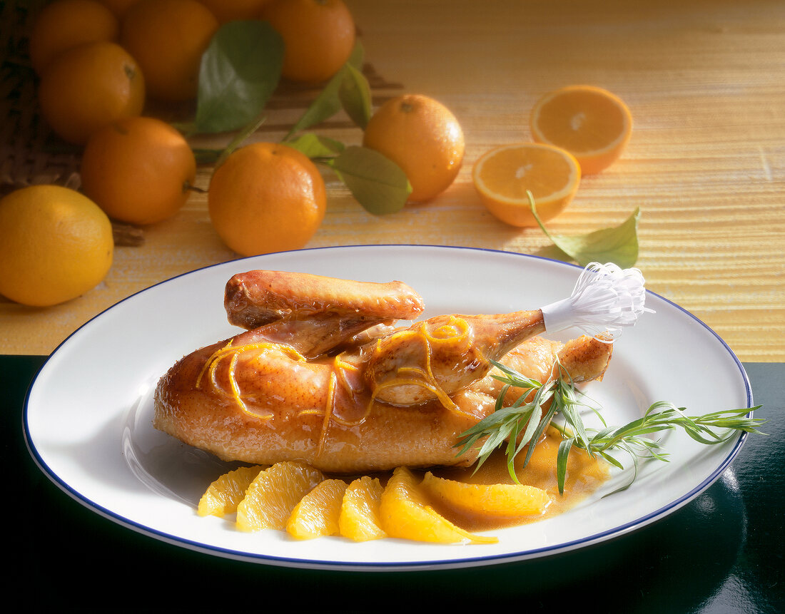 Crispy baked duck with orange sauce on plate