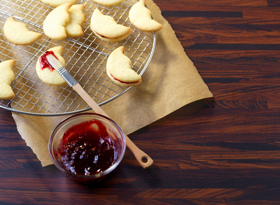 Cookies on metal grate with brush and jam