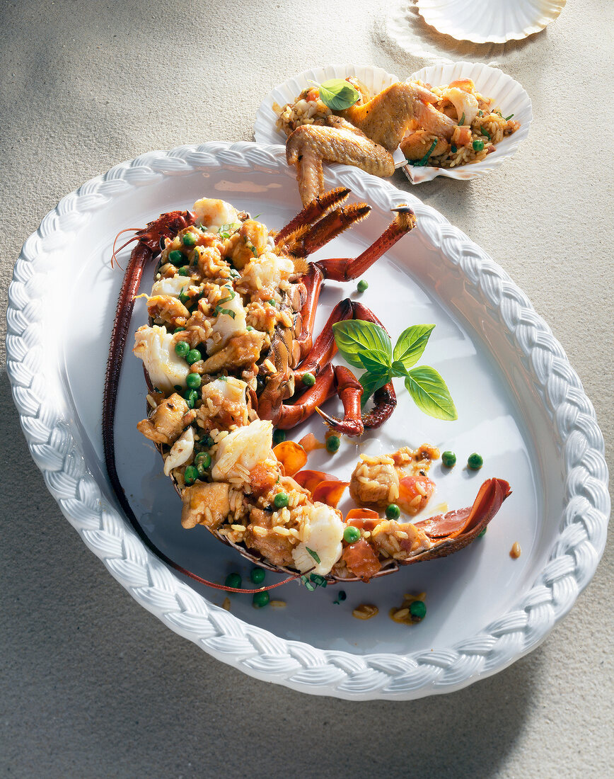 Chicken with rice and vegetables stuffed in lobster in serving dish