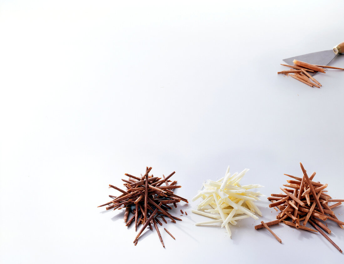 Various chocolate flakes on white background 