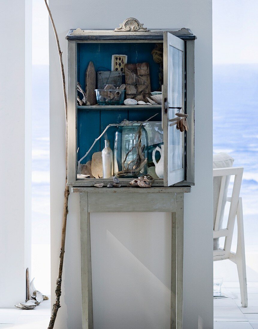 An old wooden cabinet filled with things found on the beach