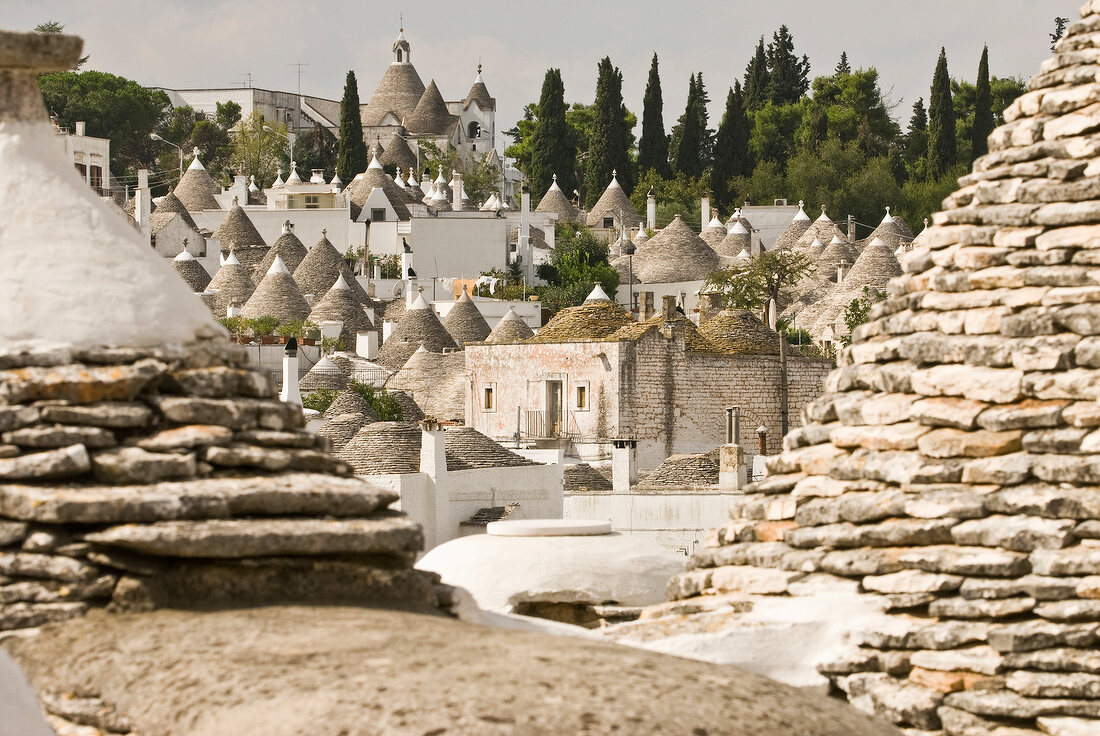 View of round stone houses with pointed roofs in Alberobello, Italy