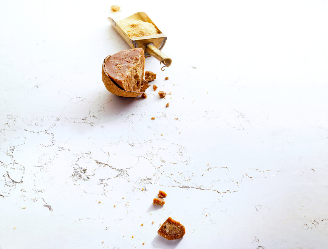 Chocolate chunks with flour scoop on white background