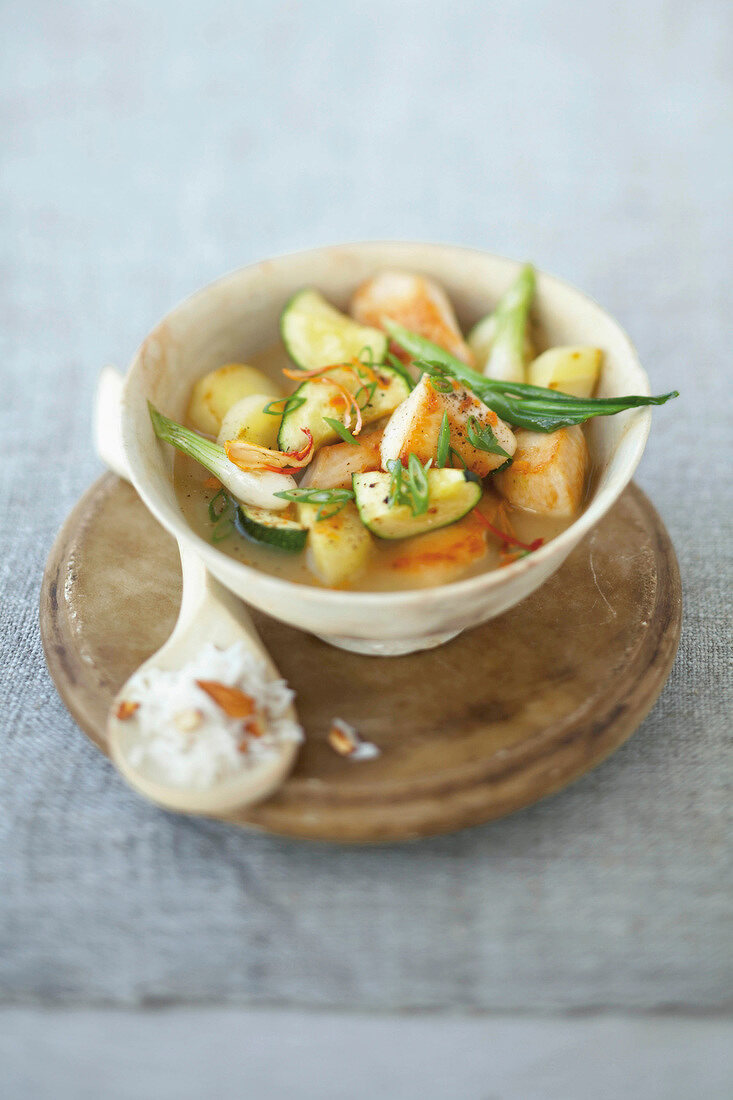 Bowl of chicken and vegetable curry with zucchini and basmati rice