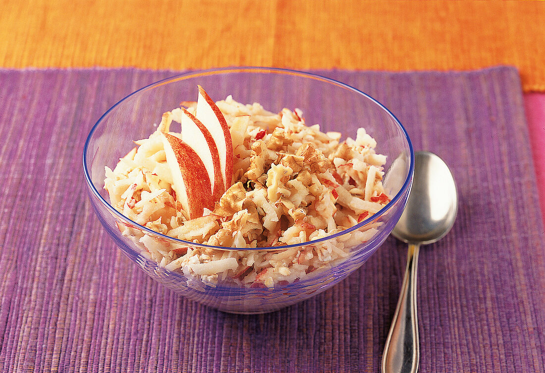 Close-up of bircher muesli with apples and walnuts in bowl