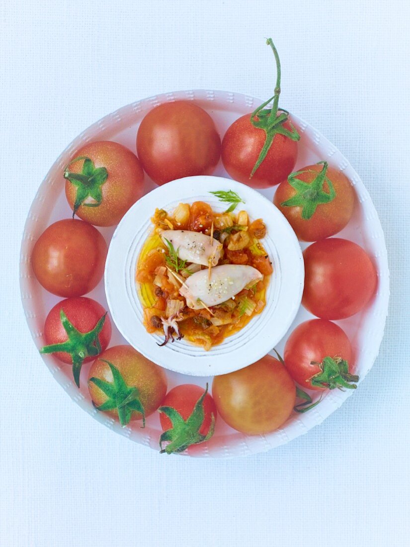 Stuffed calamaretti surrounded by tomatoes
