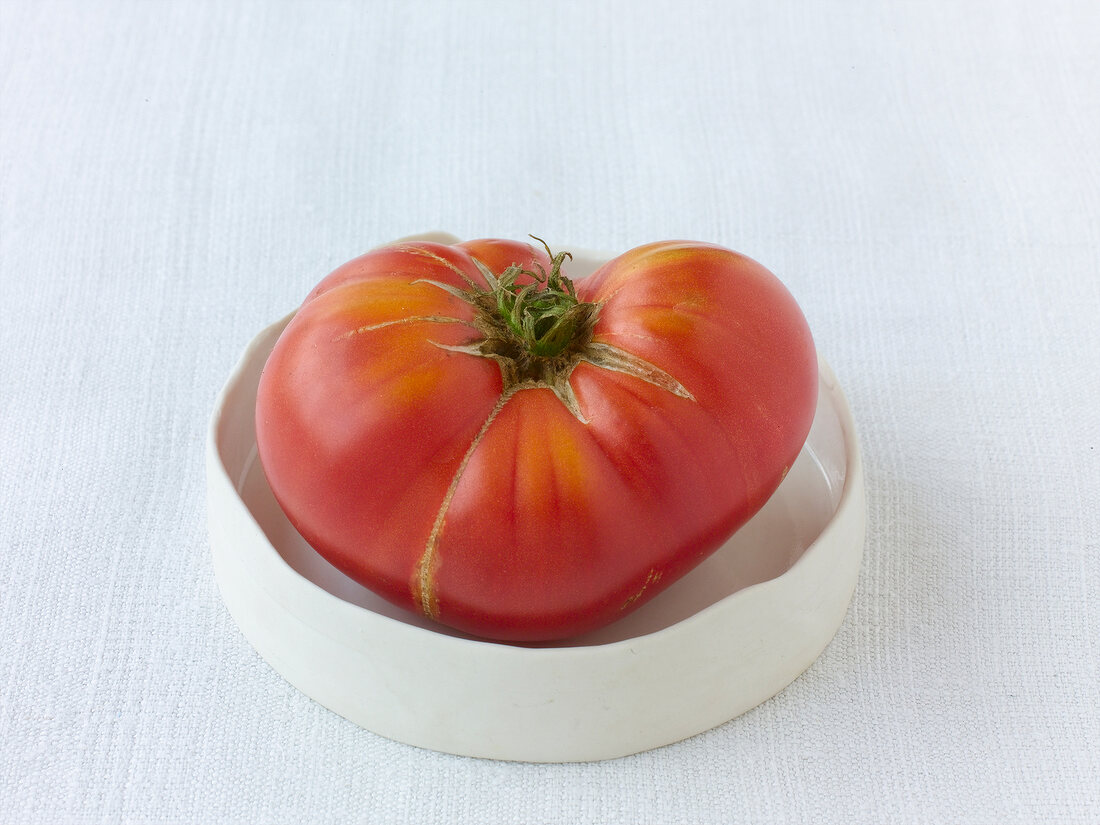 Large brandy wine red tomatoes on plate