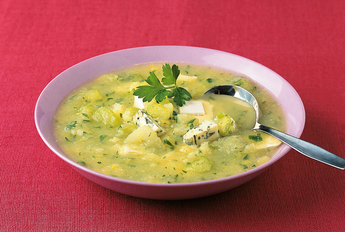 Bowl of celery cheese soup with blue cheese