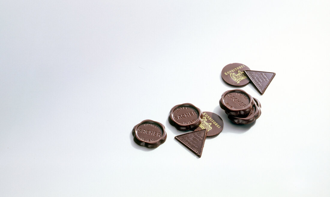 Various shaped chocolates on white background