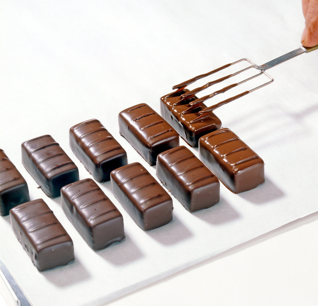 Close-up of chocolate being decorated with fork, step 5