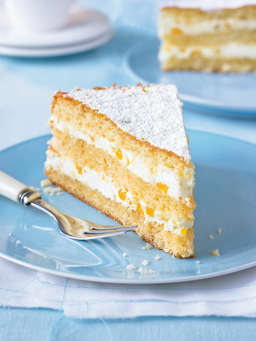 Close-up of mango and orange pie on dish with fork