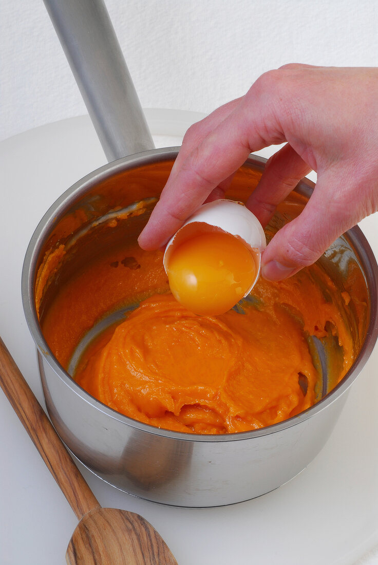 Close-up of egg yolk being added in mixture, step 2