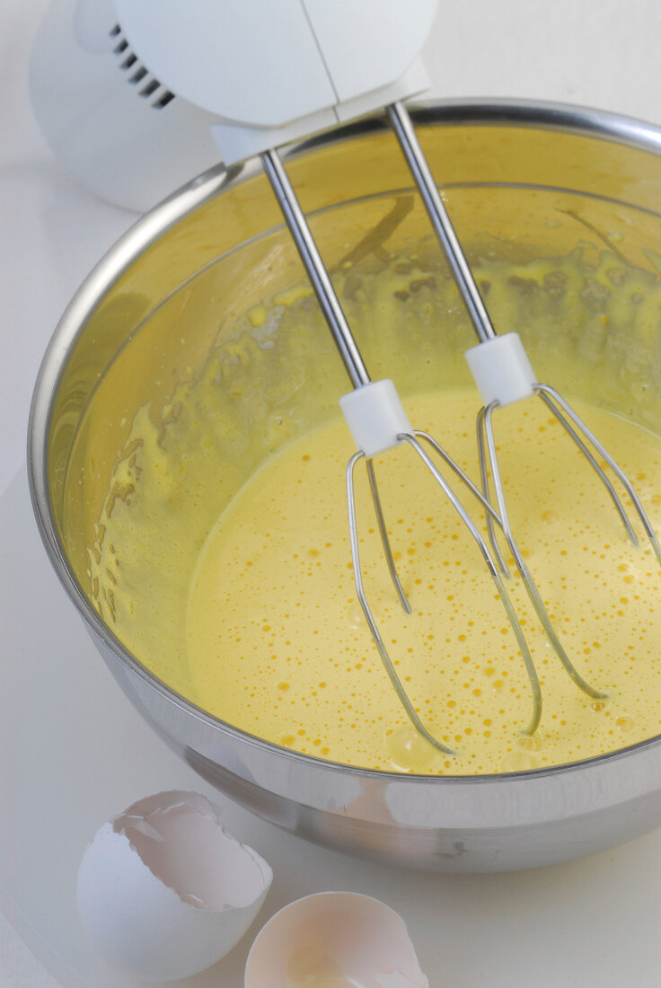 Close-up of egg sugar mixture being whisked in bowl, step 1