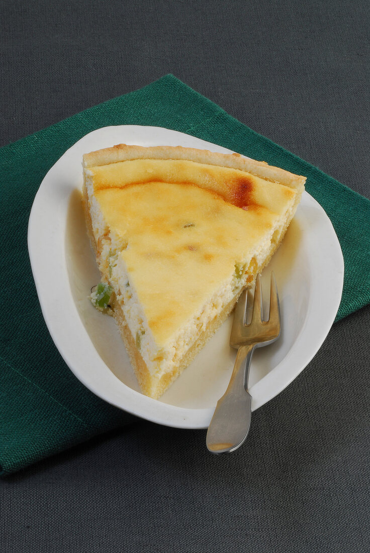 Piece of lemon flavoured ricotta tart in serving plate