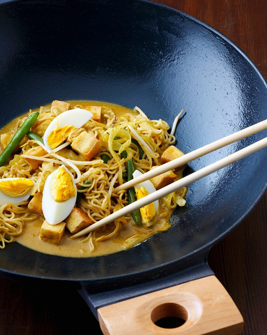 Stir-fired noodle curry with tofu and egg (Indonesia)
