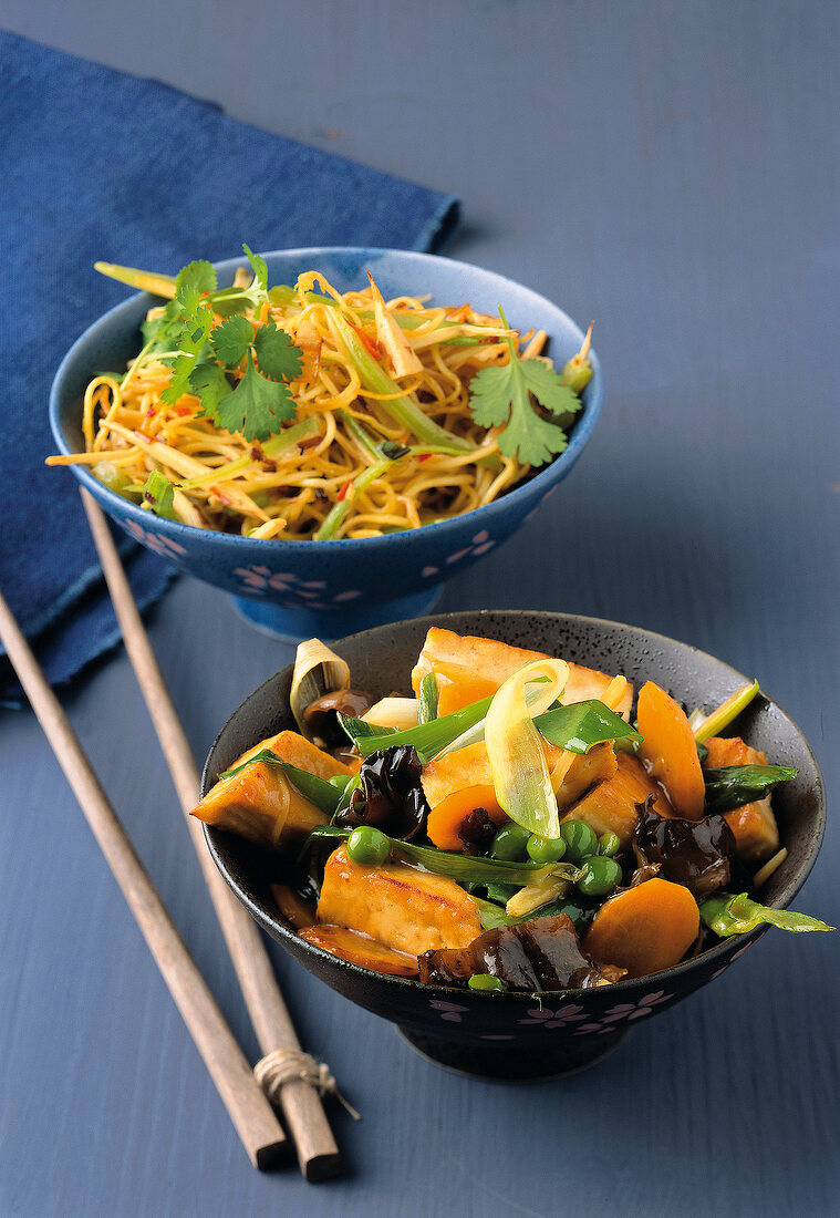 Mie noodles with bamboo and tofu with vegetables and jelly ear mushrooms in bowls