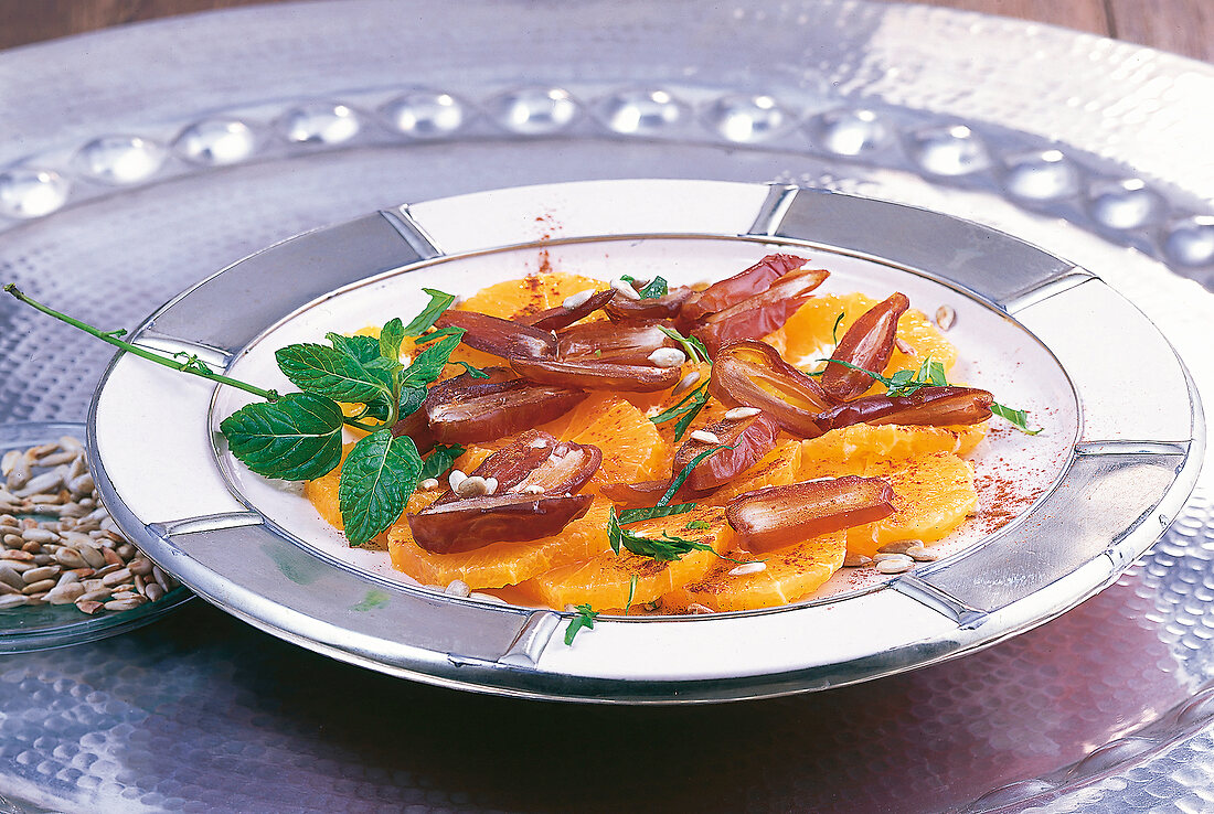 Close-up of orange and date salad with mint on dish