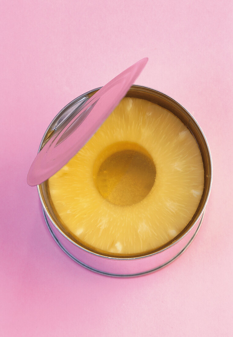 Pineapple slices in an open can, overhead view