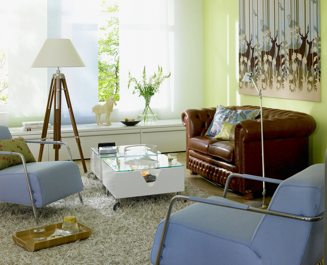 Blick in Wohnraum, Chesterfield-Sofa Glastisch, Sessel blau, Fenster