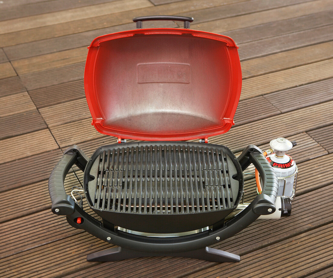 Rectangular shaped gas grill with red cap
