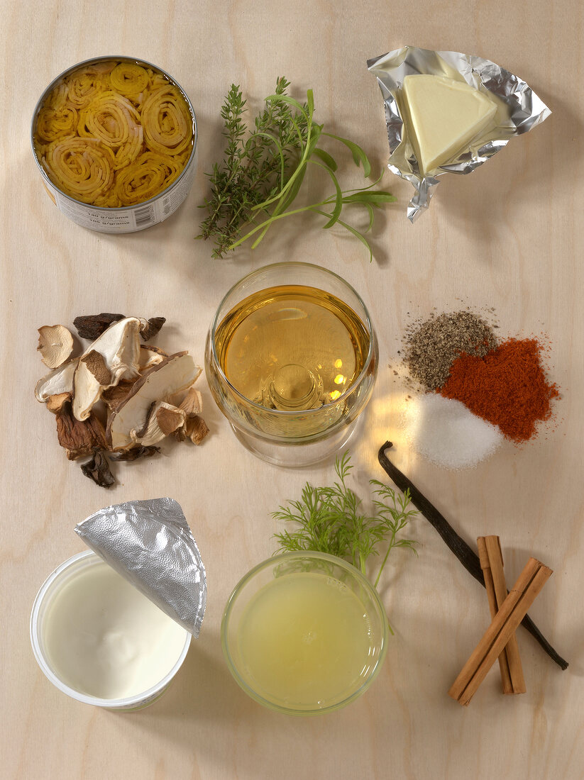 Herbs, cheese, mushrooms and other ingredients for sauces and dips on wooden board