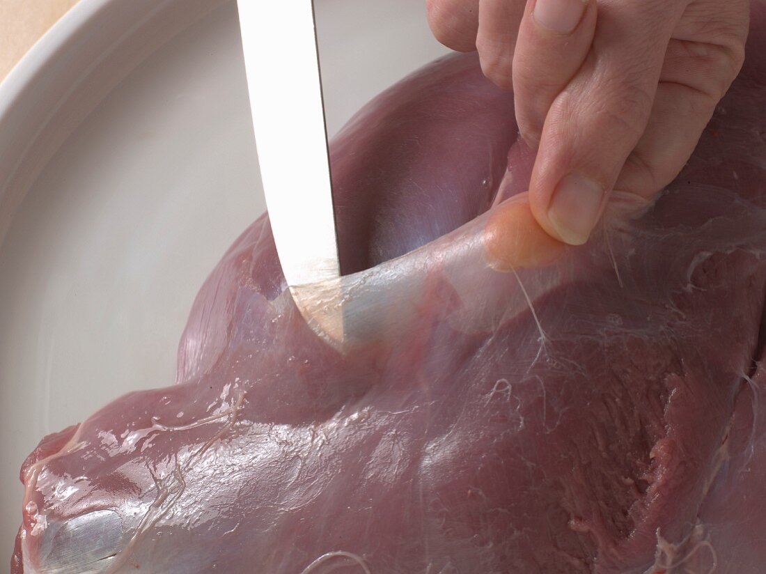 Leg of venison being skinned