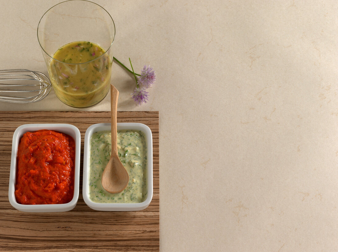 Frankfurt's green sauce and ajvar in bowls with herb vinaigrette in glass, copy space