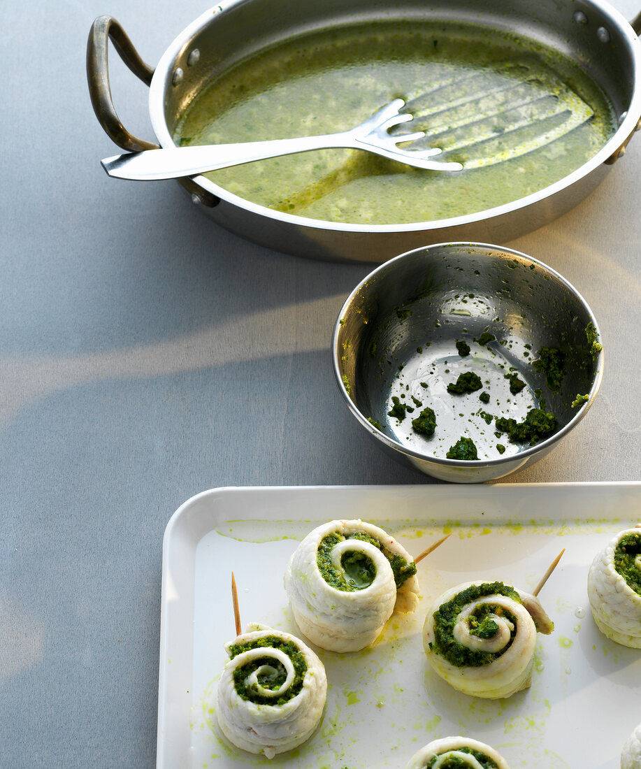 Sole rolls with tarragon and almond pesto on serving dish with frying pan on side