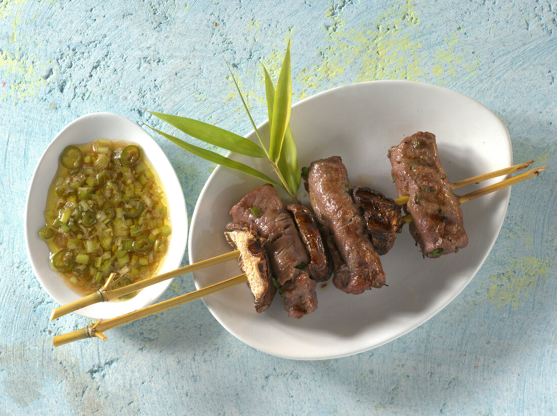 Vietnamese beef skewers with chilli and onion dip in bowls