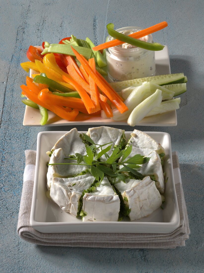 Stuffed camembert and vegetables with sheep cheese dip on two plates