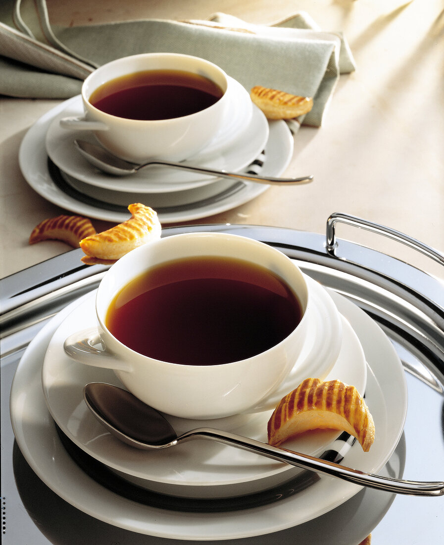 Clear oxtail soup with biscuits in bowls