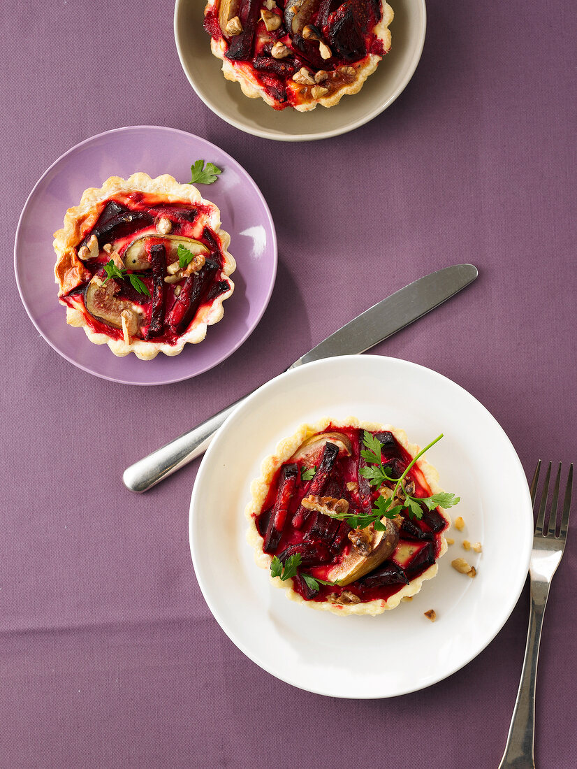 Beetroot and fig tart on three plates