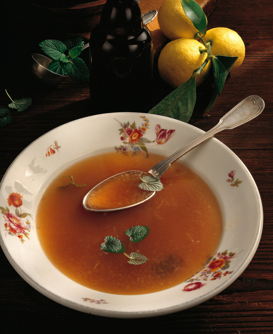 White beer soup with lemon balm on plate