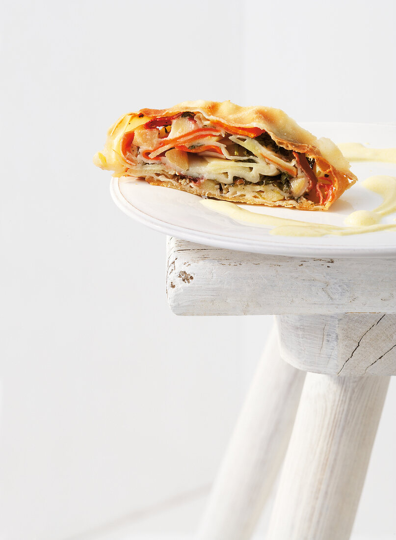 Strudel with different roots and tubers on plate