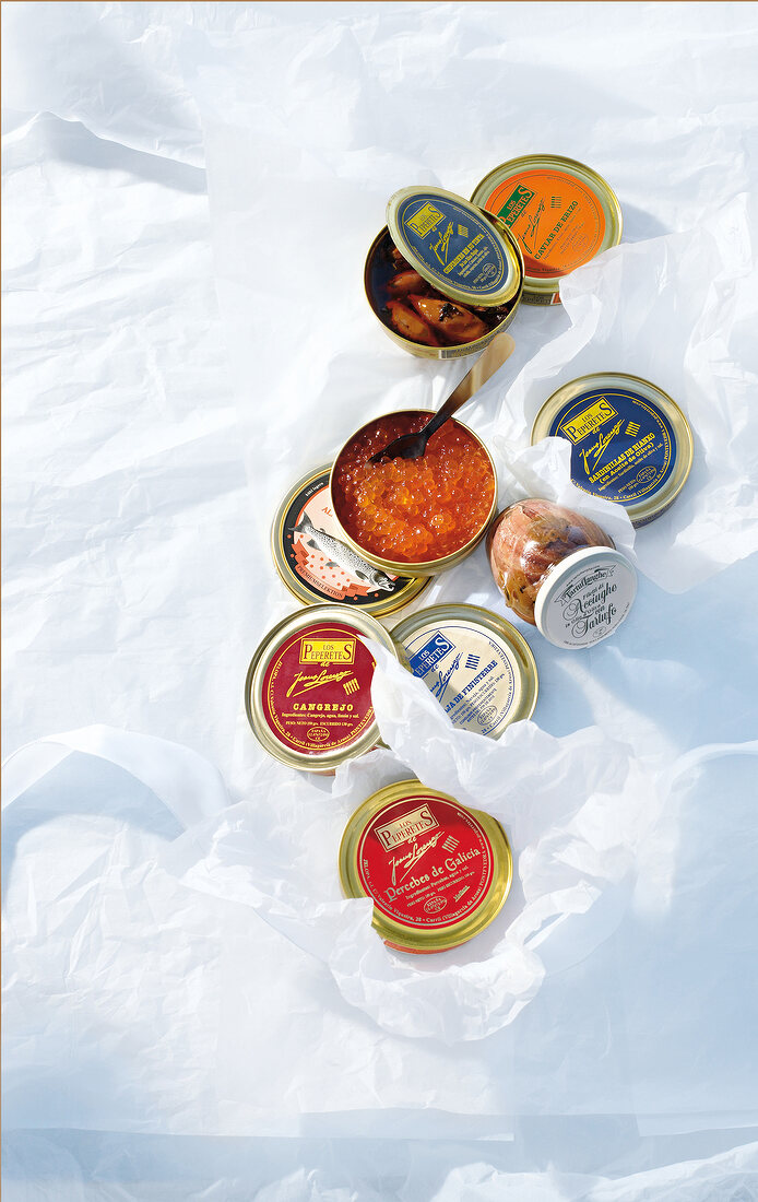 Various jars of caviar and mussels, overhead view