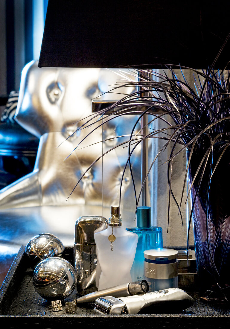 Various men care products such as razor, perfume bottles on table