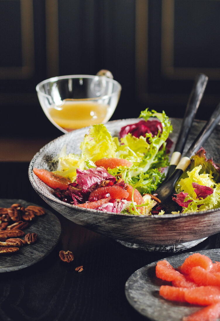Lettuce salad with pomegranate dressing in bowl